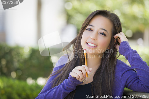 Image of Pensive Mixed Race Female Student with Pencil on Campus