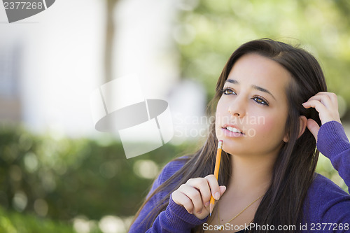Image of Pensive Mixed Race Female Student with Pencil on Campus