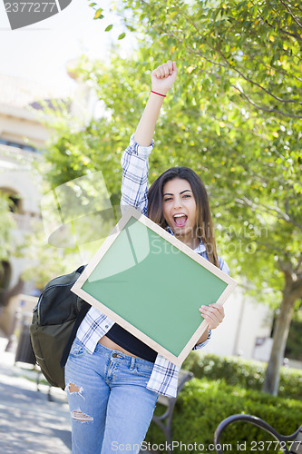 Image of Excited Mixed Race Female Student Holding Blank Chalkboard