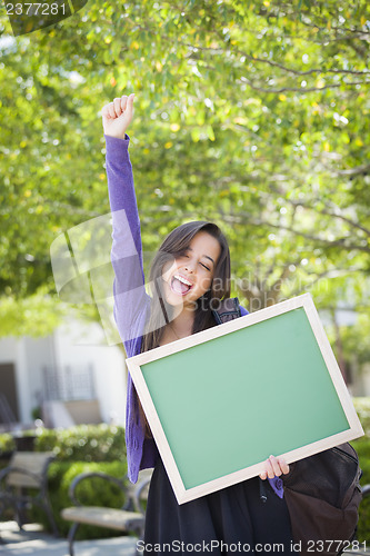 Image of Excited Mixed Race Female Student Holding Blank Chalkboard