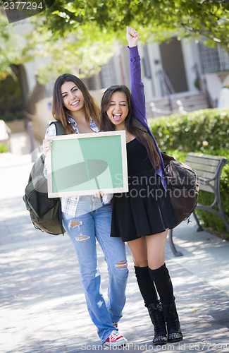 Image of Excited Mixed Race Female Students Holding Blank Chalkboard