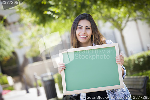 Image of Excited Mixed Race Female Student Holding Blank Chalkboard