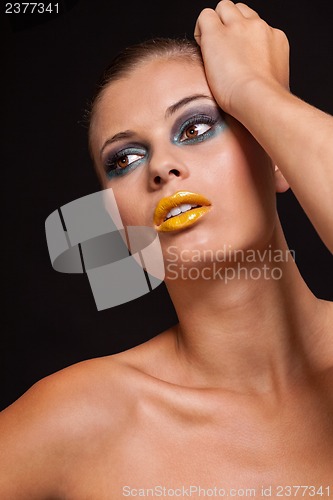 Image of woman with extreme colorfull make up in blue and yellow