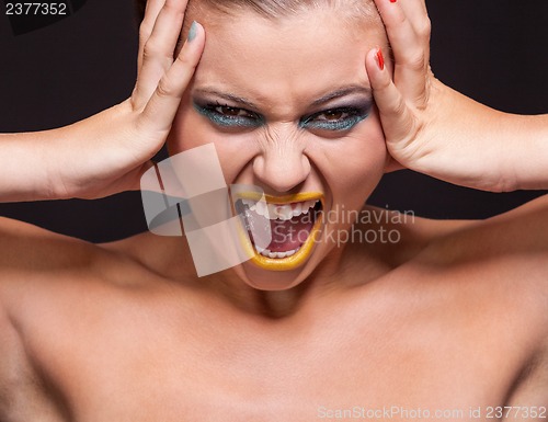 Image of attractive young woman scream out loud with yellow lipstick