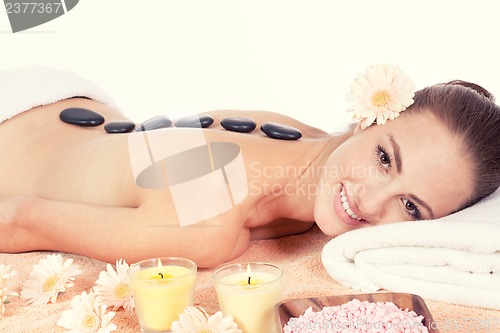 Image of attractive helathy caucasian woman hot stone massage wellness 