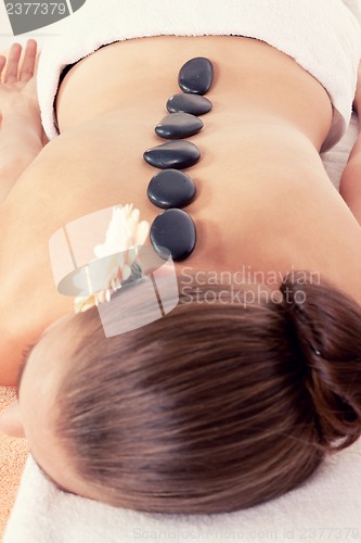 Image of attractive helathy caucasian woman hot stone massage wellness 