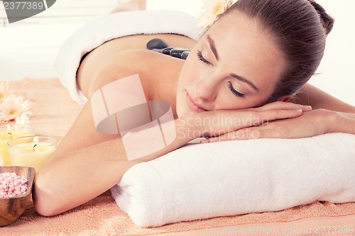 Image of attractive helathy caucasian woman hot stone massage wellness 