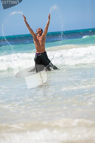 Image of attractive careree happy man in water holiday vacation summer