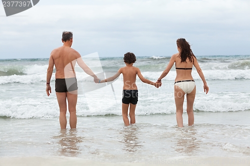 Image of happy family ith two boys having fun in water summer holiday