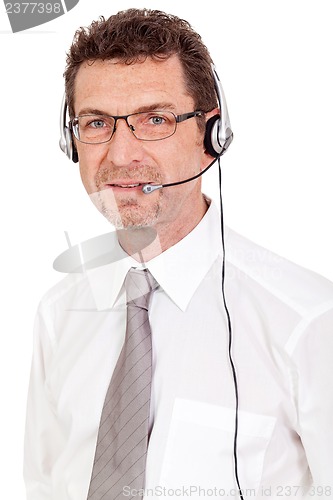 Image of smiling mature male operator businessman with headset call senter