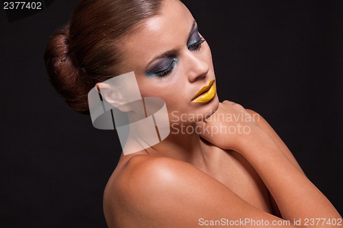 Image of woman with extreme colorfull make up in blue and yellow