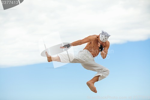 Image of man is jumping sport karate martial arts fight kick