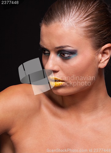 Image of woman with extreme colorfull make up in blue and yellow