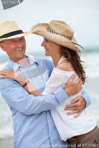 Image of happy adult couple in summertime on beach 