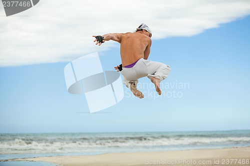 Image of man is jumping sport karate martial arts fight kick