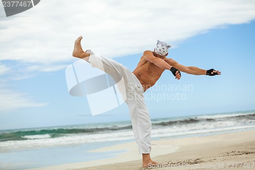 Image of man is jumping sport karate martial arts fight kick