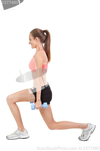 Image of young attractive woman stretching legs after jogging isolated
