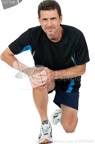 Image of adult attractive man in sportswear knee pain injury ache isolated