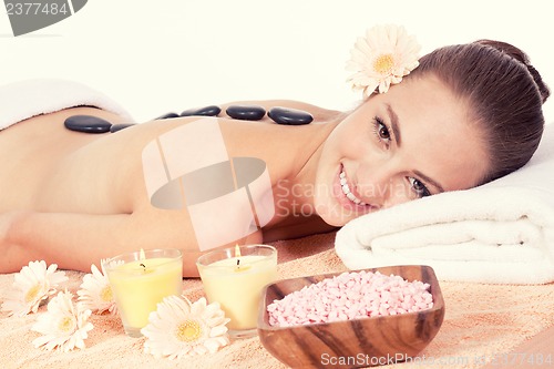 Image of attractive helathy caucasian woman hot stone massage wellness 