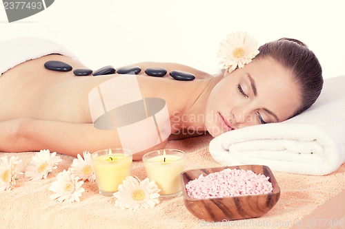 Image of attractive helathy caucasian woman hot stone massage wellness 