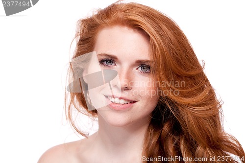 Image of beautiful young smiling woman with red hair and freckles isolated