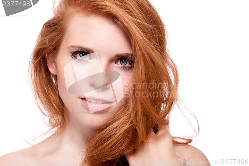 Image of beautiful young smiling woman with red hair and freckles isolated