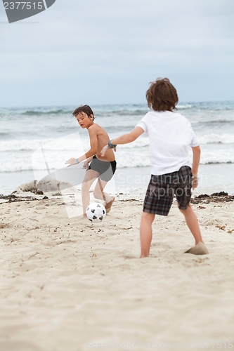 Image of happy family father two kids playing football on beach summer 