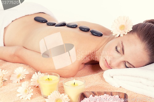 Image of attractive helathy caucasian woman hot stone massage wellness 