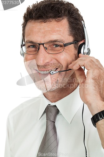 Image of smiling mature male operator businessman with headset call senter