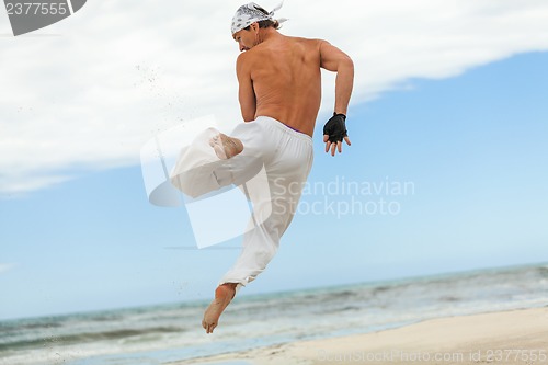 Image of man is jumping sport karate martial arts fight kick