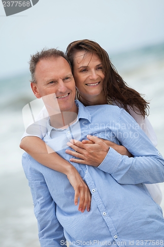 Image of happy adult couple in summertime on beach 