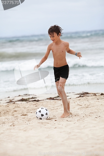 Image of happy family father two kids playing football on beach summer 