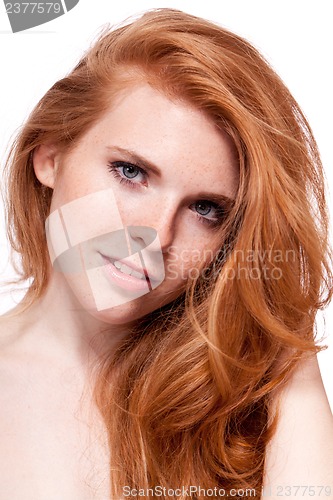 Image of beautiful young smiling woman with red hair and freckles isolated