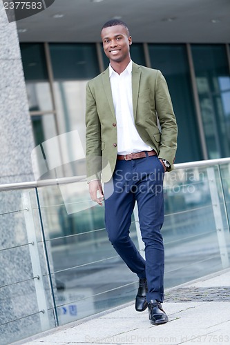 Image of young successful african business man outdoor in summer