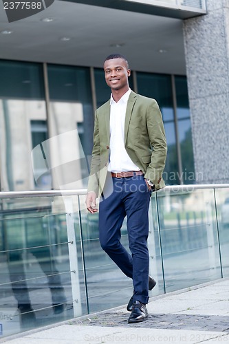 Image of young successful african business man outdoor in summer