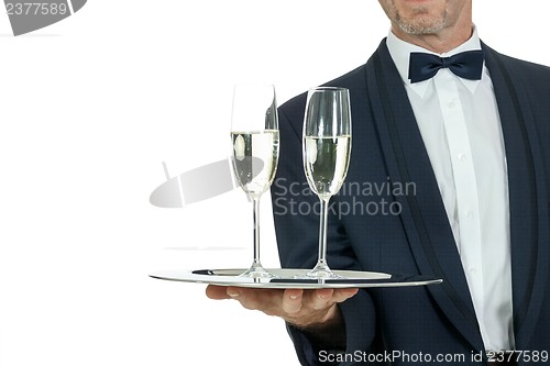 Image of adult male waiter serving two glass of champagne isolated