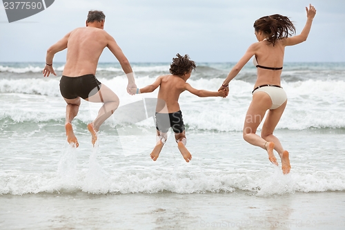 Image of happy family ith two boys having fun in water summer holiday