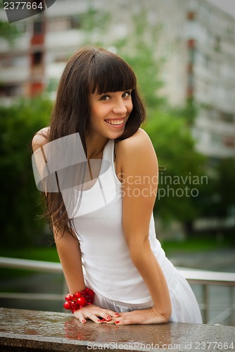 Image of Pretty smiling girl with red beads