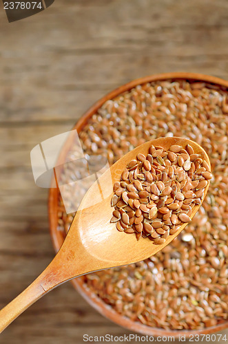 Image of close up of flax seeds and wooden spoon 
