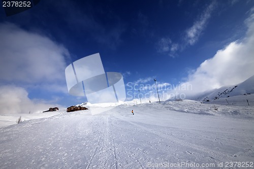 Image of Snowboarder on piste slope in nice day