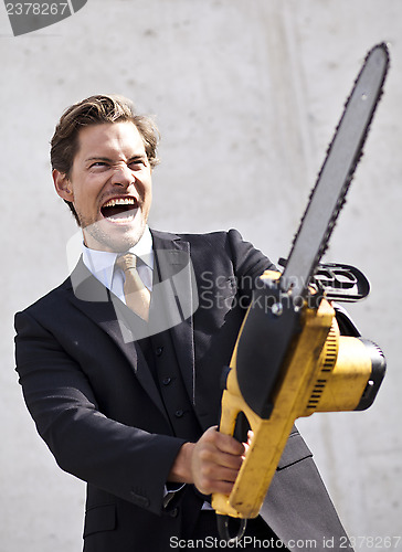 Image of Angry businessman with blurred chainsaw