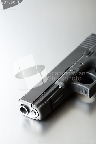Image of gun on brushed steel
