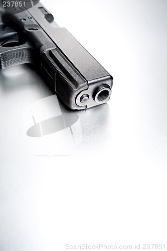 Image of gun on brushed metal background