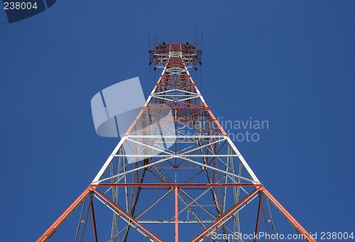 Image of Red triangular power tower in the blue sky