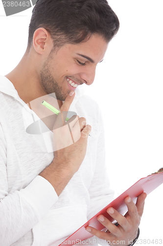 Image of Man smiling as he reads notes on a clipboard