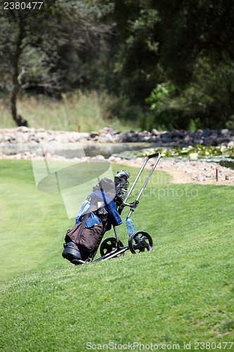 Image of Golf bag and clubs on a golf course