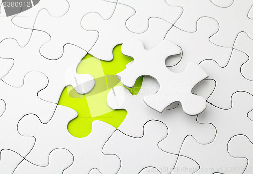 Image of Puzzle with missing piece in green color