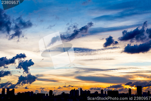 Image of City skyline silhouetted against a blue sunset