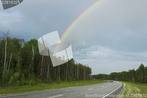 Image of Rainbow after rain over highway