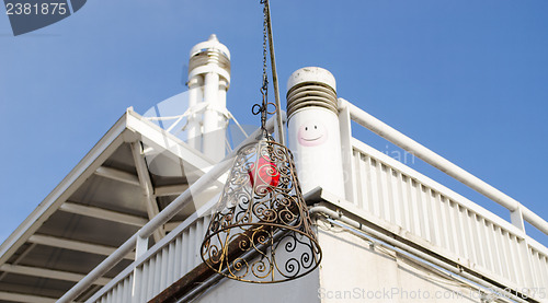 Image of building hung brass squirm lampshade red light 